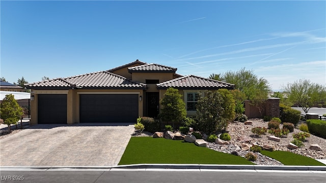 5852 Ireland Ridge Ct, Las Vegas, NV 89149 - view of front of home featuring an attached garage, stucco siding, decorative driveway, and a tiled roof