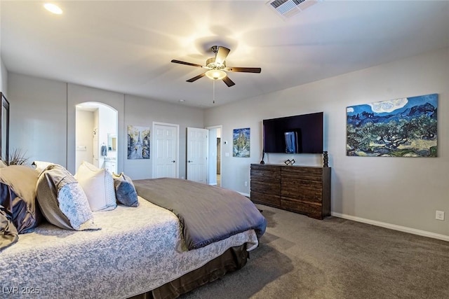 5852 Ireland Ridge Ct, Las Vegas, NV 89149 - bedroom with arched walkways, carpet floors, baseboards, a ceiling fan, and connected bathroom