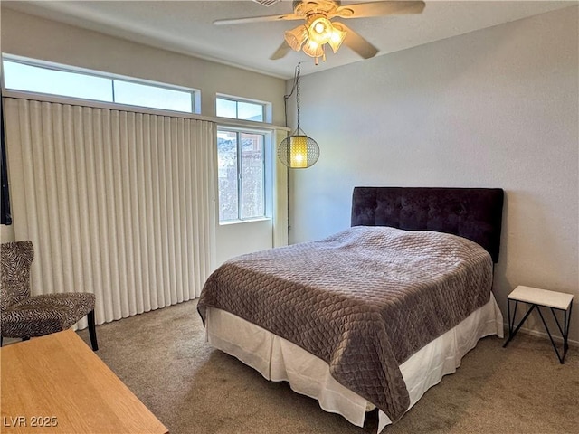 bedroom featuring a ceiling fan and carpet