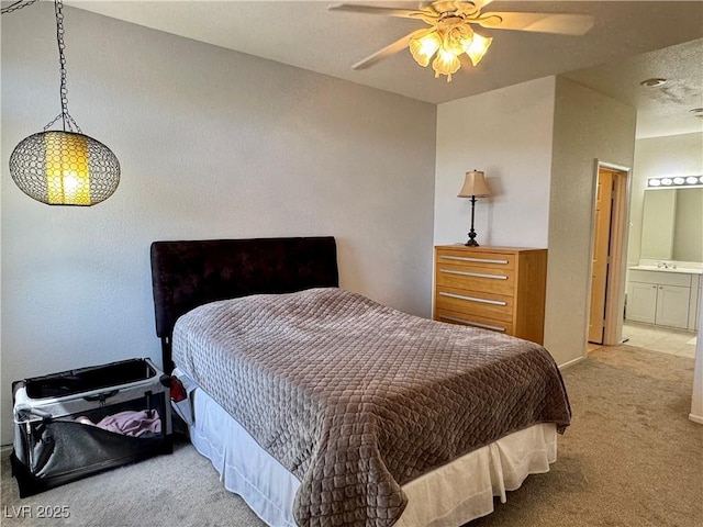 bedroom featuring carpet, a ceiling fan, and connected bathroom