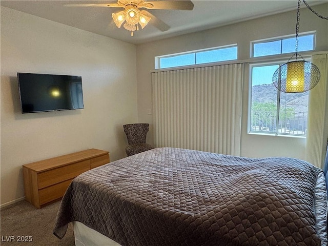 bedroom featuring ceiling fan and carpet