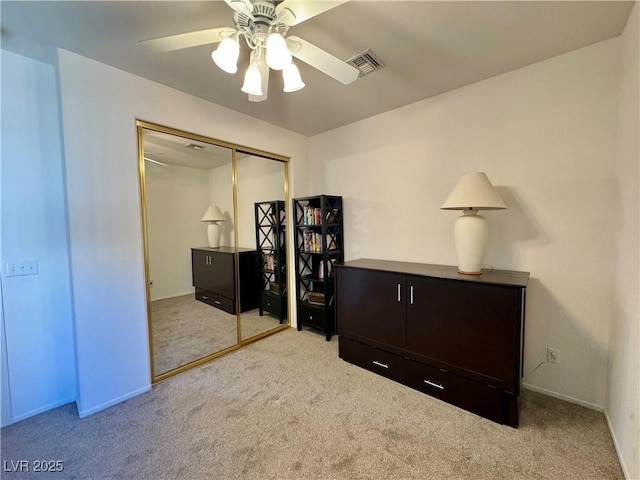 bedroom with carpet, a closet, a ceiling fan, and visible vents