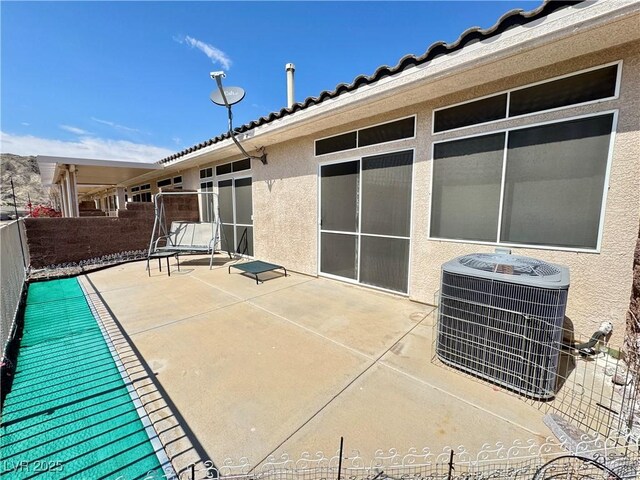 view of patio / terrace with central AC unit and fence