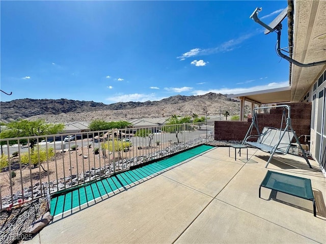 view of patio / terrace with a mountain view and a balcony