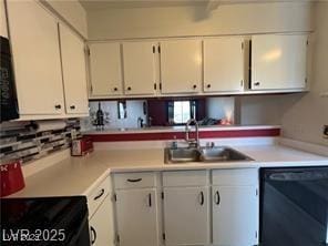 kitchen with white cabinets, light countertops, a sink, and black dishwasher
