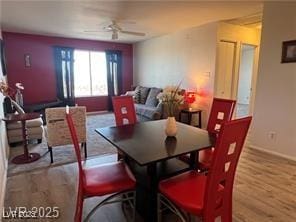dining area featuring baseboards, a ceiling fan, and wood finished floors