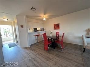 dining area featuring wood finished floors, visible vents, and a ceiling fan