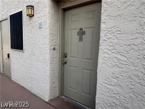 entrance to property featuring stucco siding