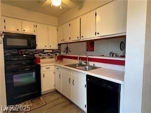 kitchen featuring white cabinets, light countertops, a sink, black appliances, and ceiling fan