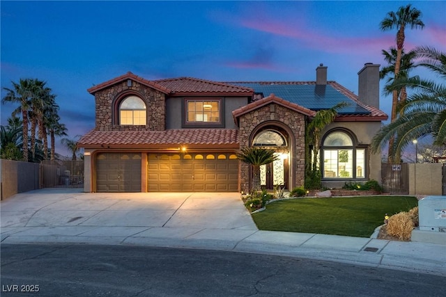3924 Diamond Ridge St, Las Vegas, NV 89129 - mediterranean / spanish house featuring a tile roof, stucco siding, a chimney, and stone siding