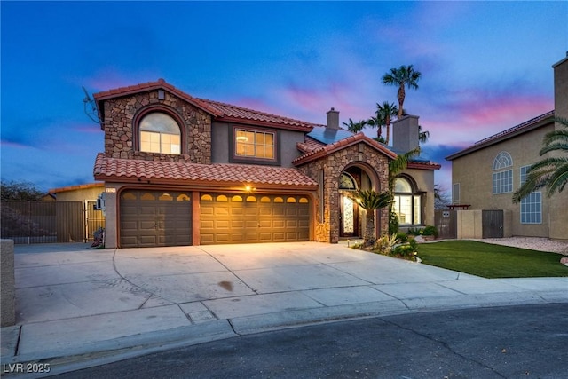 3924 Diamond Ridge St, Las Vegas, NV 89129 - mediterranean / spanish home with driveway, a tile roof, stucco siding, and stone siding