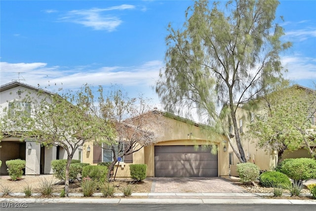 2104 Leatherbridge Ct, North Las Vegas, NV 89081 - obstructed view of property with an attached garage, stucco siding, and decorative driveway