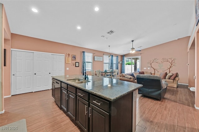 2104 Leatherbridge Ct, North Las Vegas, NV 89081 - kitchen with a sink, ceiling fan, light wood-style floors, a kitchen island with sink, and stainless steel dishwasher