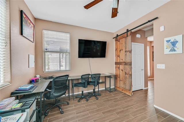 2104 Leatherbridge Ct, North Las Vegas, NV 89081 - office area with a barn door, a ceiling fan, baseboards, and plenty of natural light