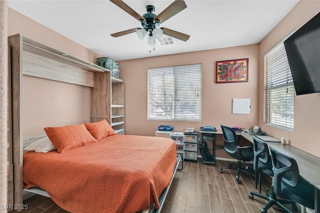 2104 Leatherbridge Ct, North Las Vegas, NV 89081 - bedroom featuring a desk, wood finished floors, a ceiling fan, and baseboards