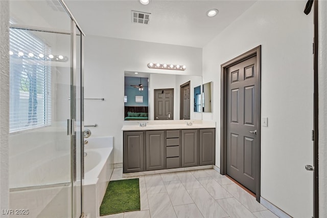 2104 Leatherbridge Ct, North Las Vegas, NV 89081 - full bath with double vanity, a stall shower, a bath, marble look tile flooring, and recessed lighting