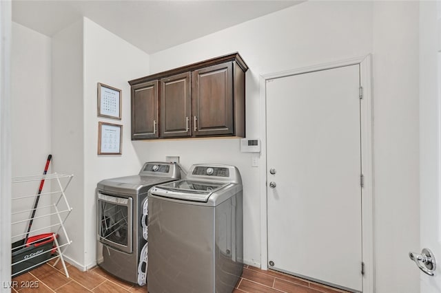 2104 Leatherbridge Ct, North Las Vegas, NV 89081 - washroom featuring washer and dryer, cabinet space, wood tiled floors, and baseboards