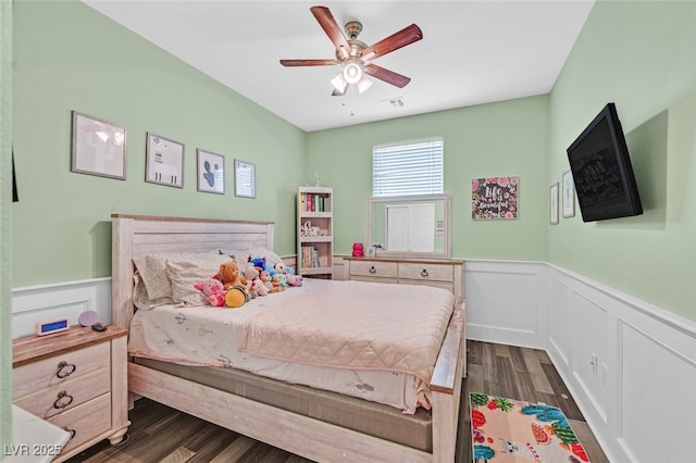 2104 Leatherbridge Ct, North Las Vegas, NV 89081 - bedroom featuring wainscoting, dark wood-style flooring, a ceiling fan, and a decorative wall