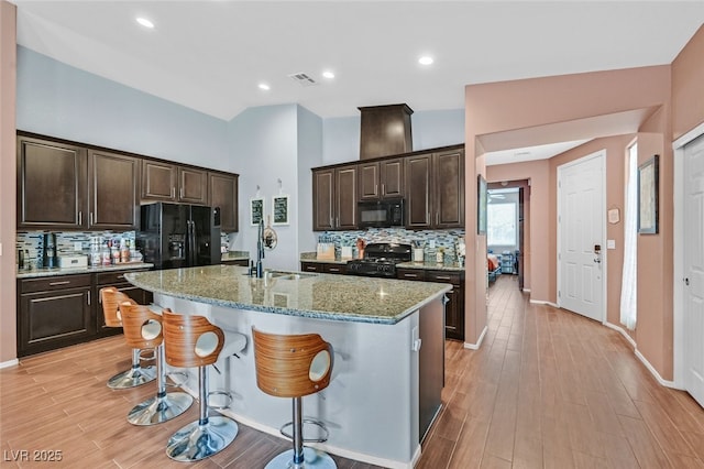 2104 Leatherbridge Ct, North Las Vegas, NV 89081 - kitchen featuring black appliances, a sink, backsplash, and dark brown cabinetry