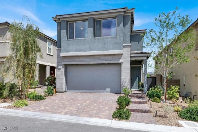 12426 Oregon Cherry Ave, Las Vegas, NV 89138 - view of front of house featuring stucco siding, an attached garage, and decorative driveway