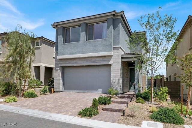 12426 Oregon Cherry Ave, Las Vegas, NV 89138 - view of front of property with stucco siding, a garage, and decorative driveway