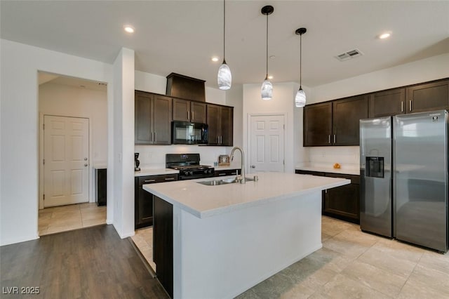 1004 Huckburn Ave, Henderson, NV 89015 - kitchen with light countertops, dark brown cabinetry, a sink, and black appliances