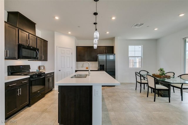 1004 Huckburn Ave, Henderson, NV 89015 - kitchen featuring recessed lighting, light countertops, visible vents, a sink, and black appliances
