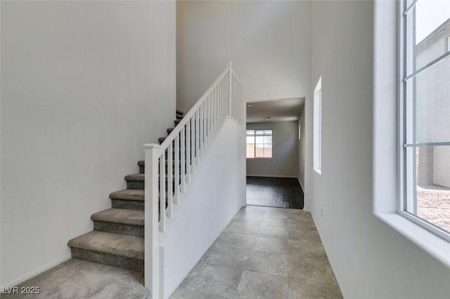 1004 Huckburn Ave, Henderson, NV 89015 - stairs featuring baseboards and a towering ceiling