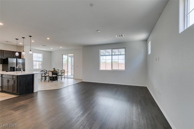 1004 Huckburn Ave, Henderson, NV 89015 - unfurnished living room featuring a sink, baseboards, visible vents, recessed lighting, and wood finished floors
