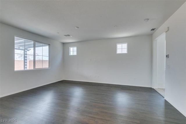 1004 Huckburn Ave, Henderson, NV 89015 - unfurnished room featuring baseboards, a healthy amount of sunlight, and dark wood-style floors
