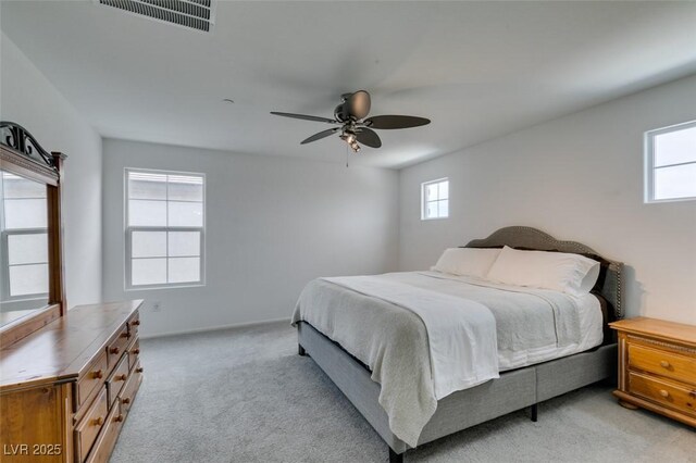 1004 Huckburn Ave, Henderson, NV 89015 - bedroom featuring ceiling fan, visible vents, light colored carpet, and multiple windows