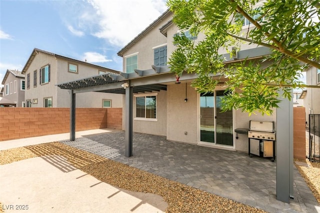 1004 Huckburn Ave, Henderson, NV 89015 - rear view of property with stucco siding, a pergola, a patio, and a fenced backyard