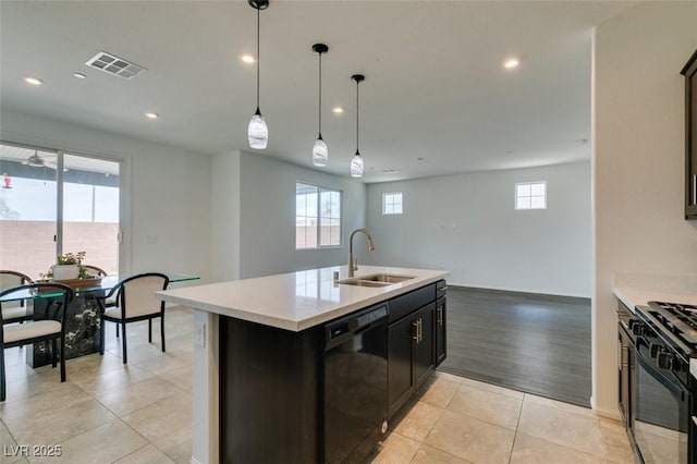 1004 Huckburn Ave, Henderson, NV 89015 - kitchen featuring light countertops, visible vents, light tile patterned floors, a sink, and black appliances