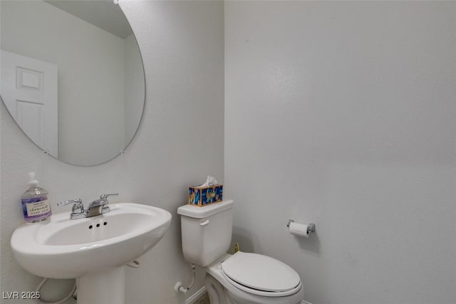 1004 Huckburn Ave, Henderson, NV 89015 - bathroom with baseboards, toilet, and a sink