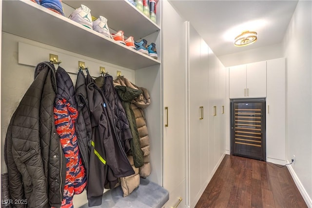 mudroom featuring dark wood finished floors, baseboards, and beverage cooler