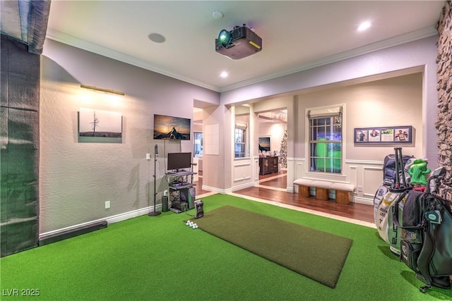 exercise room featuring recessed lighting, carpet flooring, ornamental molding, and a wainscoted wall