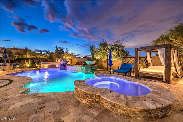 view of pool with a fenced backyard, a pool with connected hot tub, and a patio