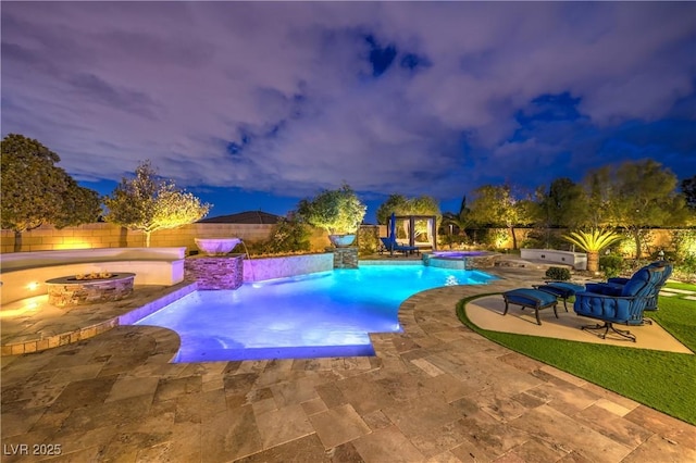 view of swimming pool with a fire pit, a pool with connected hot tub, a fenced backyard, and a patio