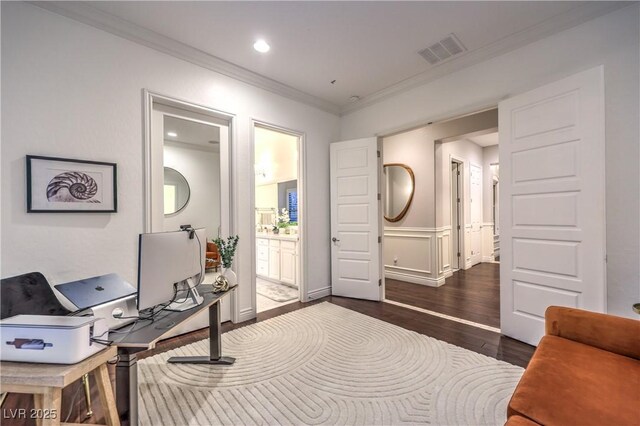 office space featuring wood finished floors, visible vents, baseboards, and ornamental molding