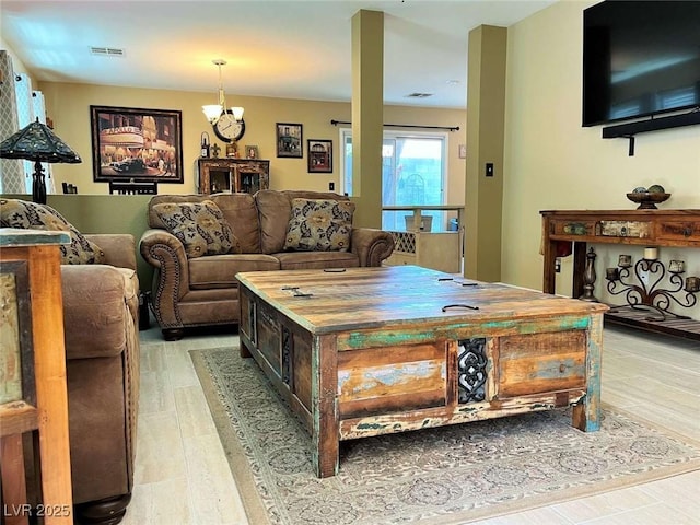 1121 Majestic Canyon St, Henderson, NV 89052 - living area with light wood-type flooring, a notable chandelier, and visible vents