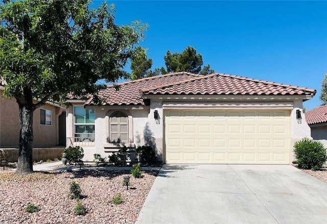 1121 Majestic Canyon St, Henderson, NV 89052 - mediterranean / spanish home featuring a tile roof, an attached garage, stucco siding, and driveway