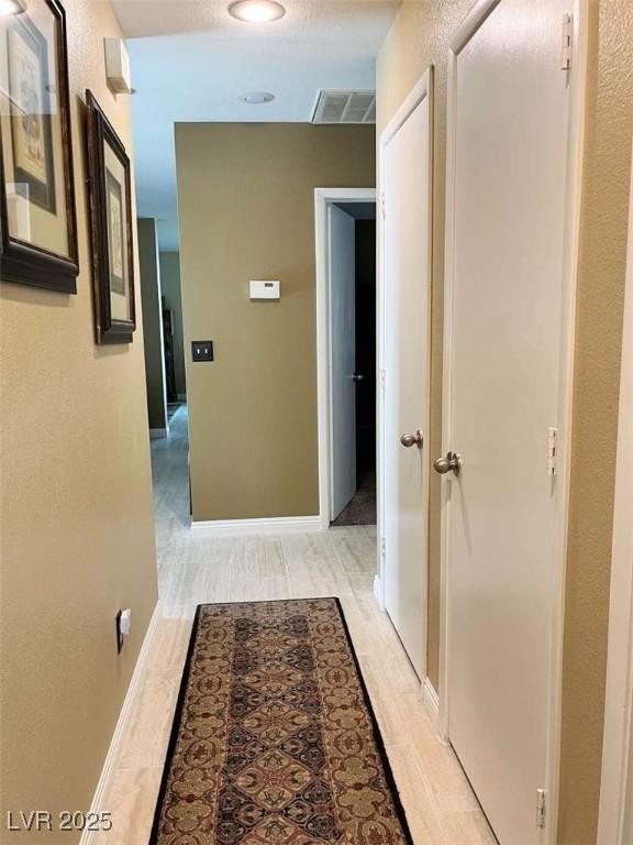 1121 Majestic Canyon St, Henderson, NV 89052 - hall featuring light wood-style flooring, baseboards, and visible vents