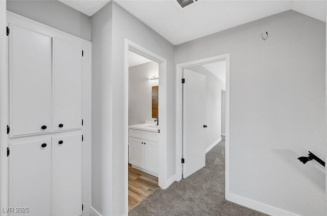 3791 El Camino Rd, Las Vegas, NV 89103 - hallway with light carpet and a sink