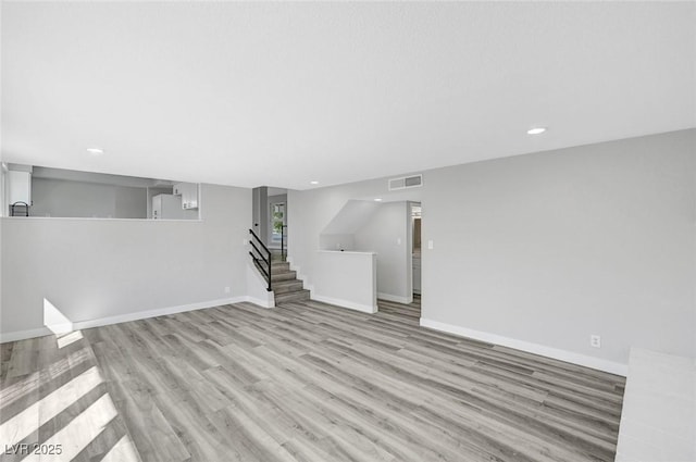 3791 El Camino Rd, Las Vegas, NV 89103 - unfurnished living room with wood finished floors, recessed lighting, and stairway