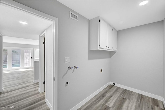 3791 El Camino Rd, Las Vegas, NV 89103 - laundry area featuring hookup for an electric dryer, cabinet space, light wood-type flooring, and recessed lighting