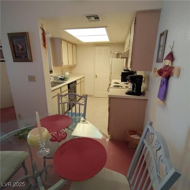 kitchen with light countertops, dishwasher, and visible vents