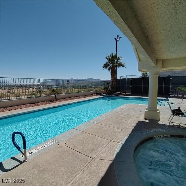 community pool featuring fence and a patio area