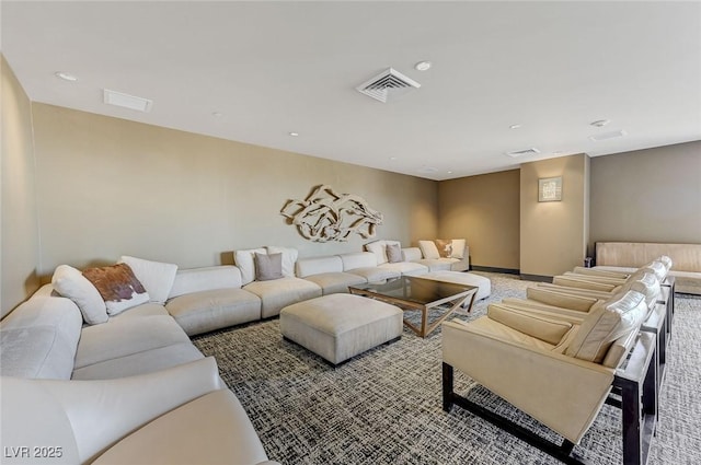 living area with recessed lighting, visible vents, and light carpet