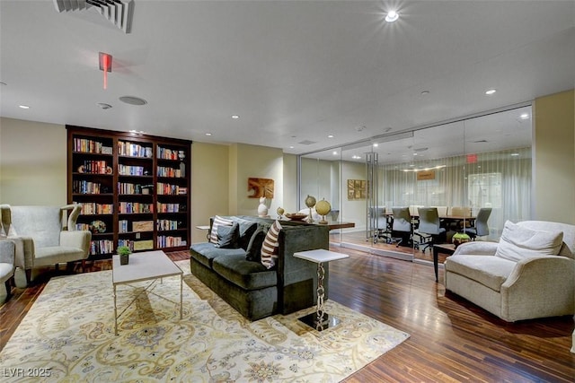 living area featuring recessed lighting, wood finished floors, and visible vents