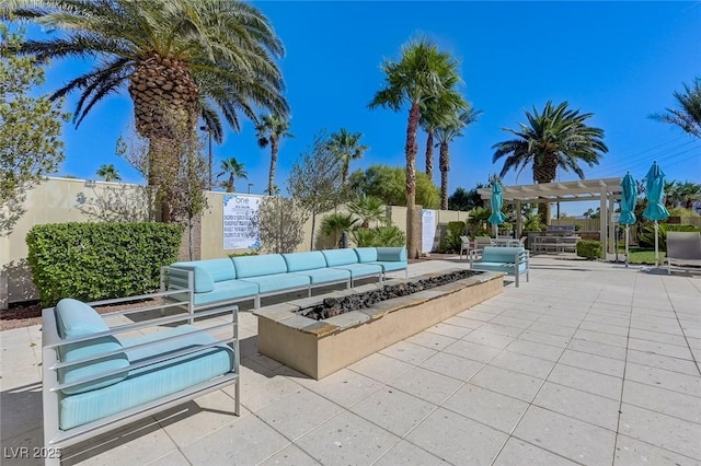 view of patio / terrace featuring fence, an outdoor living space with a fire pit, and a pergola